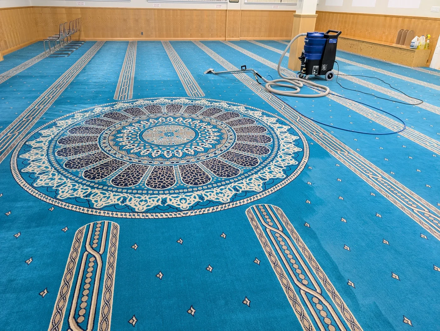Blue patterned hall carpet with extraction equipment