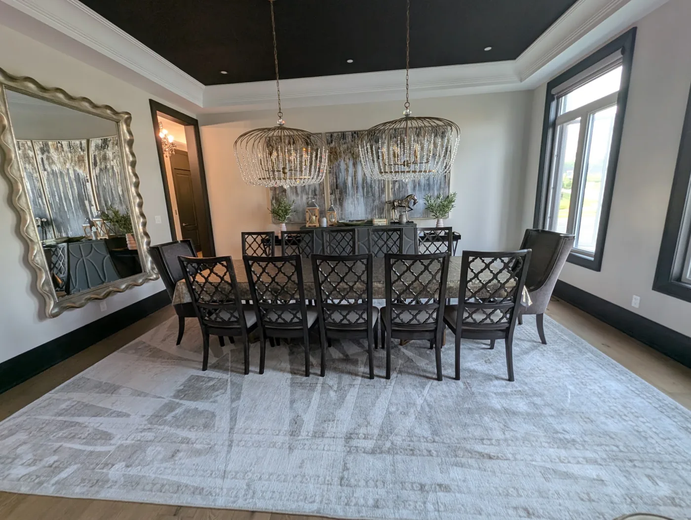 Large area rug beneath a dining table and chairs