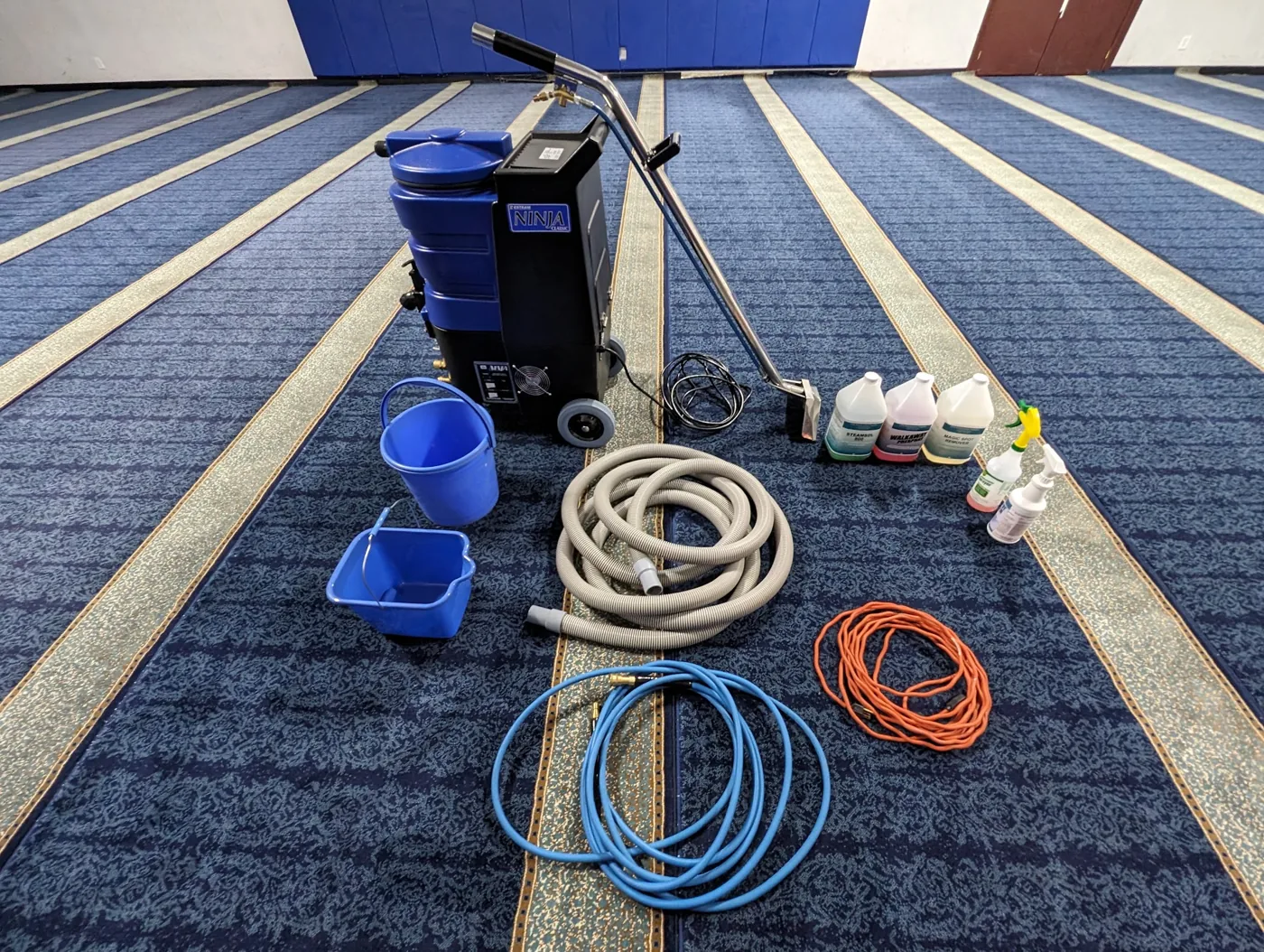 Carpet extractor, hoses and cleaning supplies