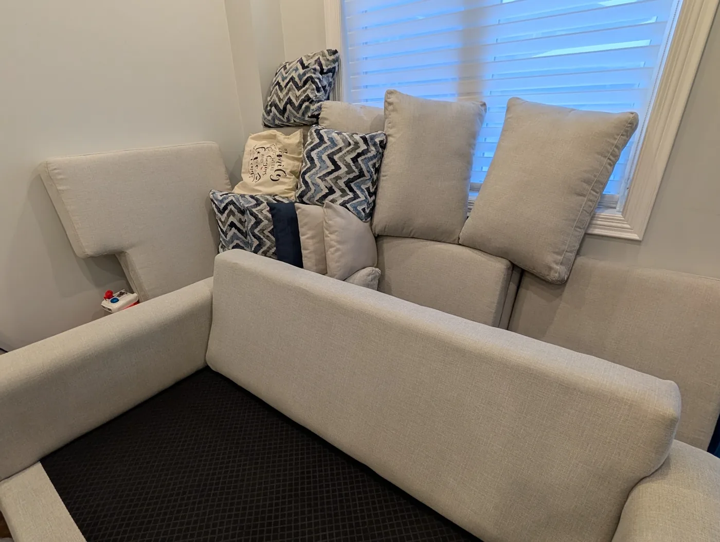 Sofa cushions arranged upright during a cleaning visit