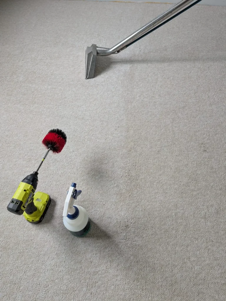 Extraction wand, drill brush and spray bottle on carpet